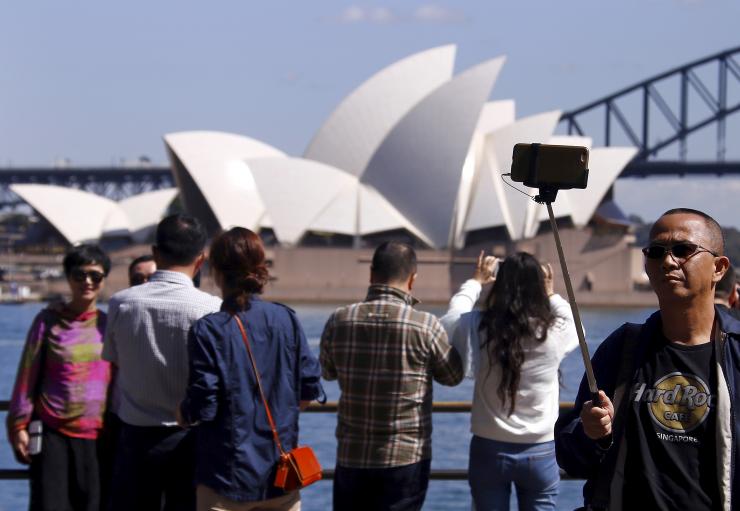 <p>Chinese tourists in front of the Opera House in Sydney</p>